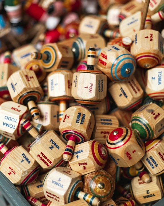 many wooden toy rockets sitting in a bin