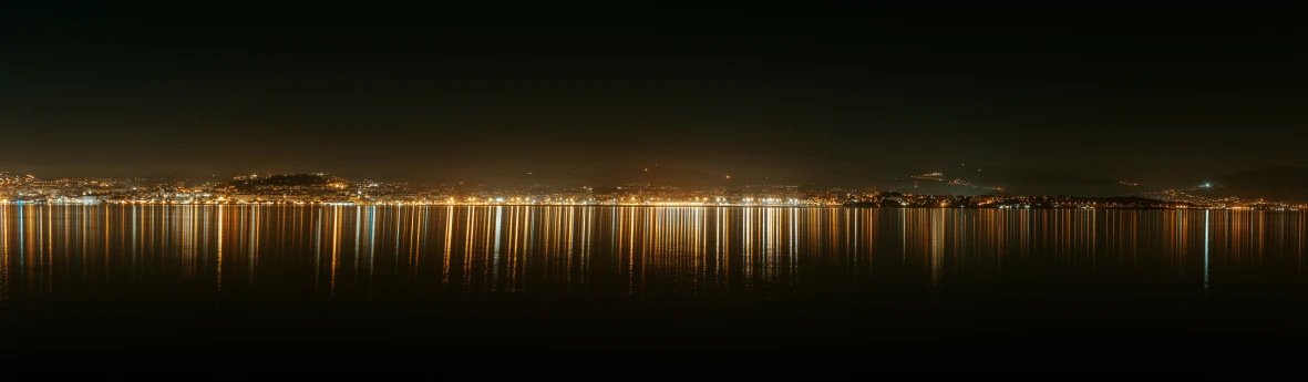 the view of a city skyline from across the water at night