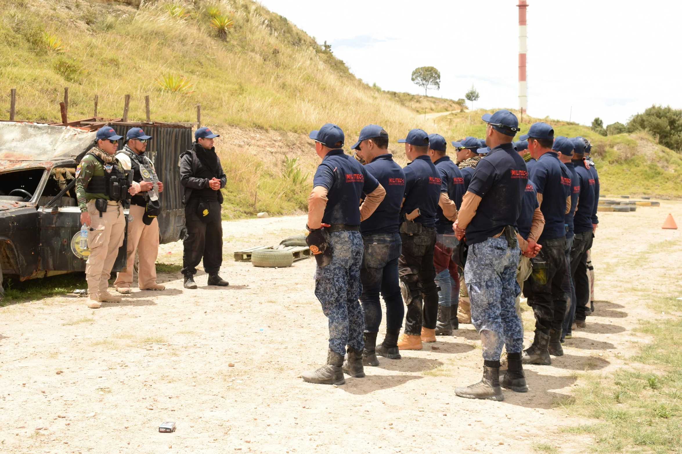 a number of police men in uniform near a broken truck