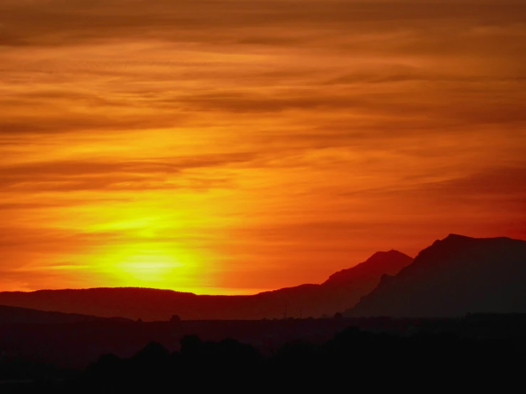 the sunset, as seen from the mountaintops above