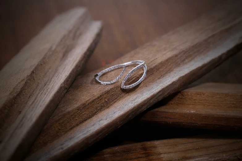 a couple of rings sitting on top of a wooden object