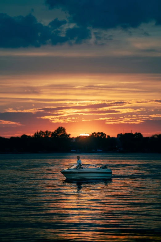 a boat in the water as the sun rises