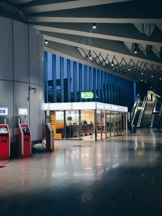 a large airport terminal with two pay phones