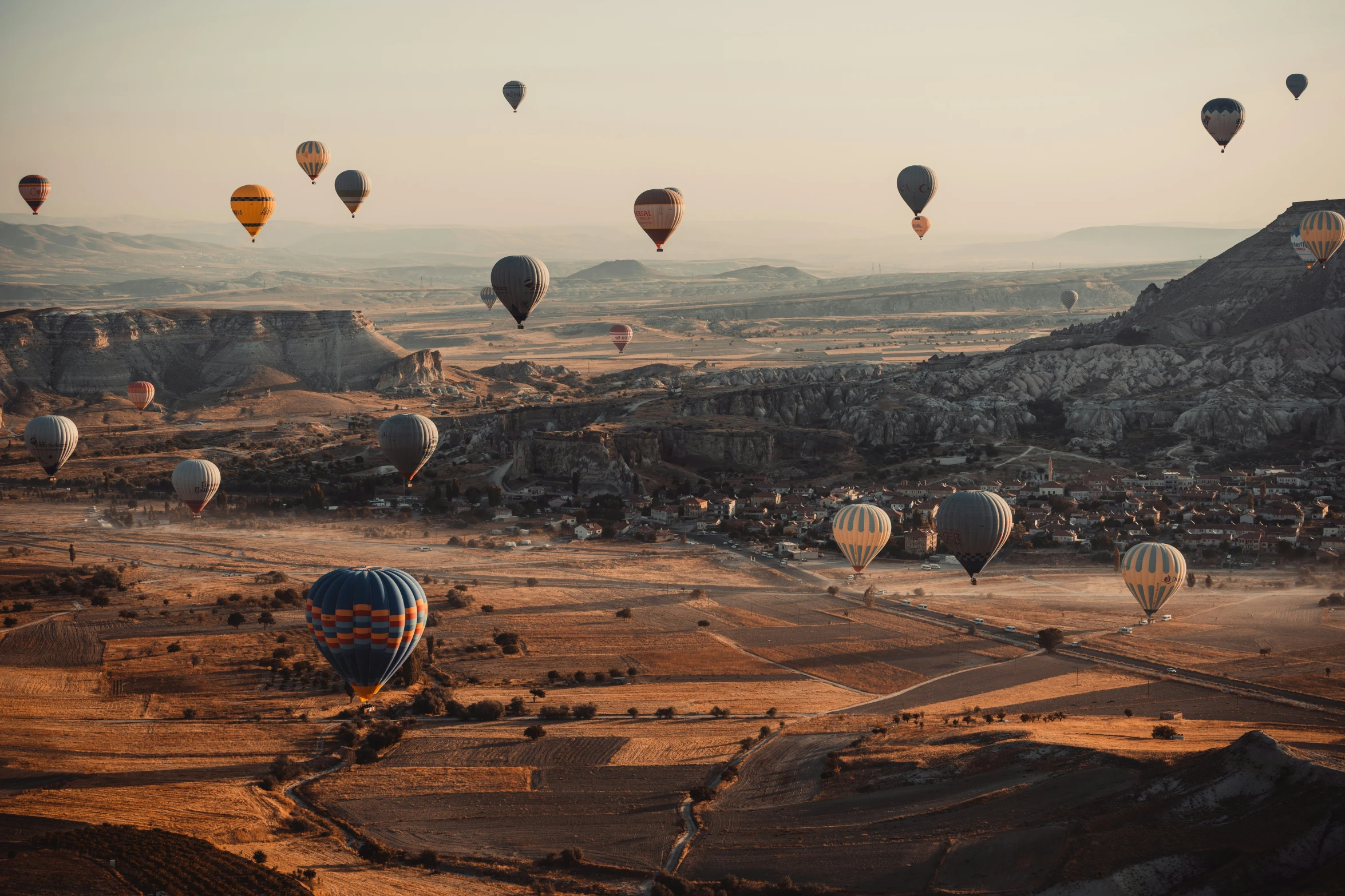 a lot of  air balloons fly over the ground