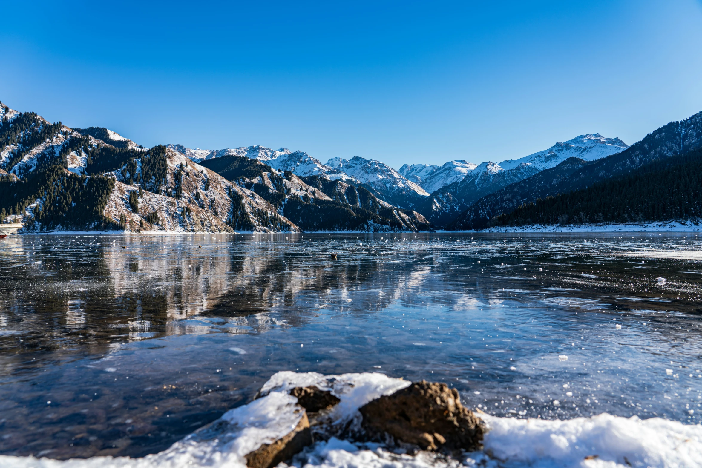 a mountain landscape with a body of water