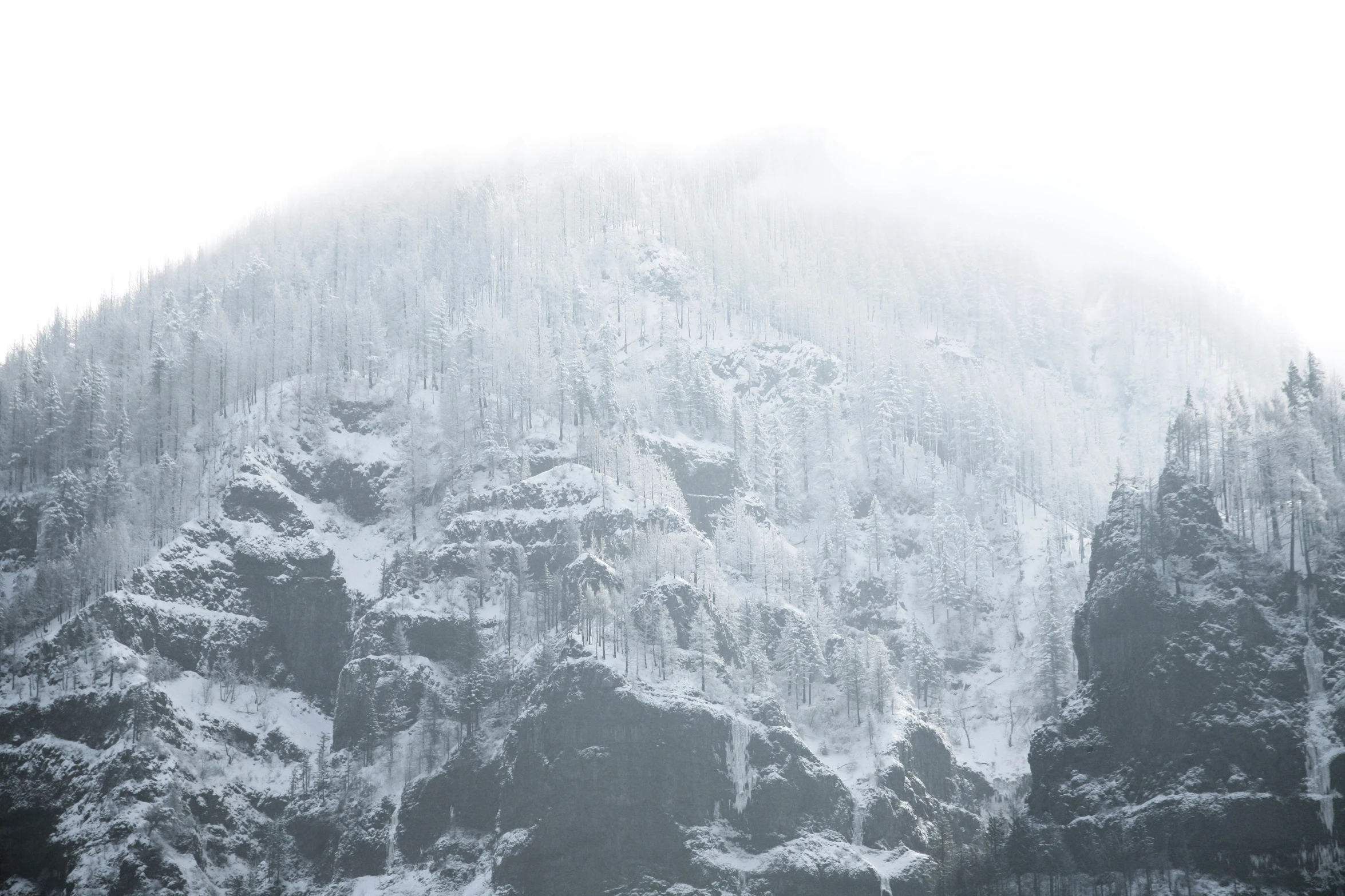 there is a mountain covered in snow and snow flakes