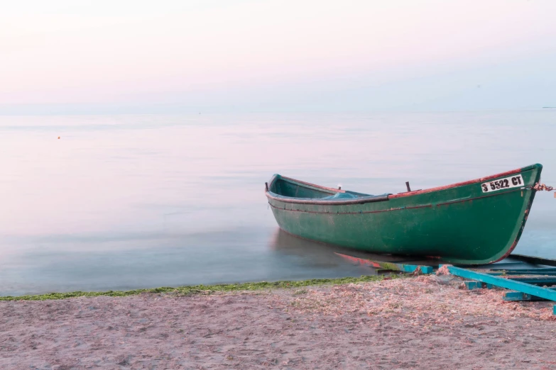 a boat is on the shore with foggy water