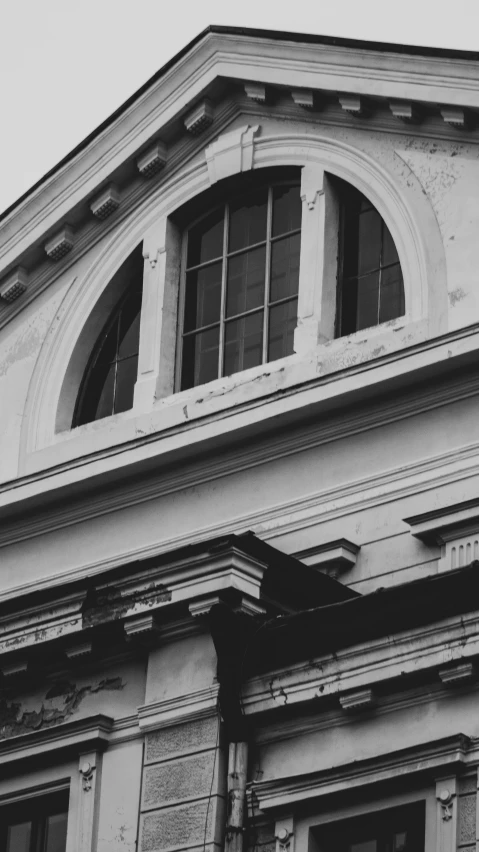 black and white pograph of old building with balcony, windows and balconies