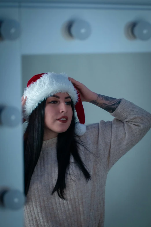 a girl is dressed up in a santa hat