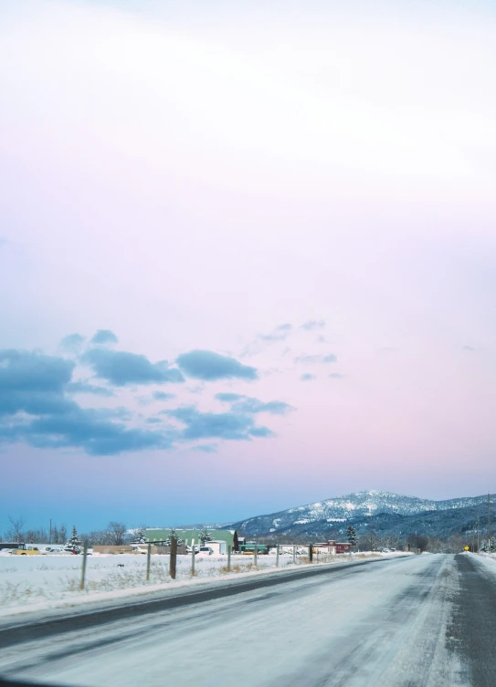 the view from a windshield on a snowy road