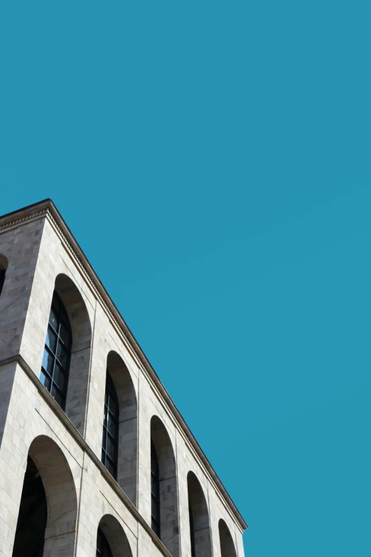 a large building with windows against the sky