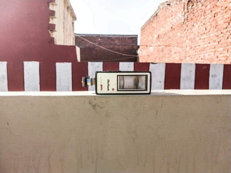 the radio has ons on it and is next to a brick wall