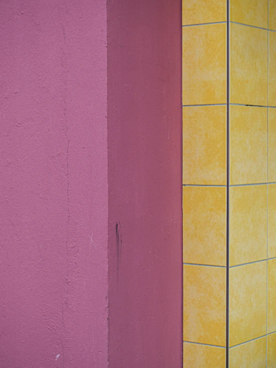 a red yellow and pink corner of a building