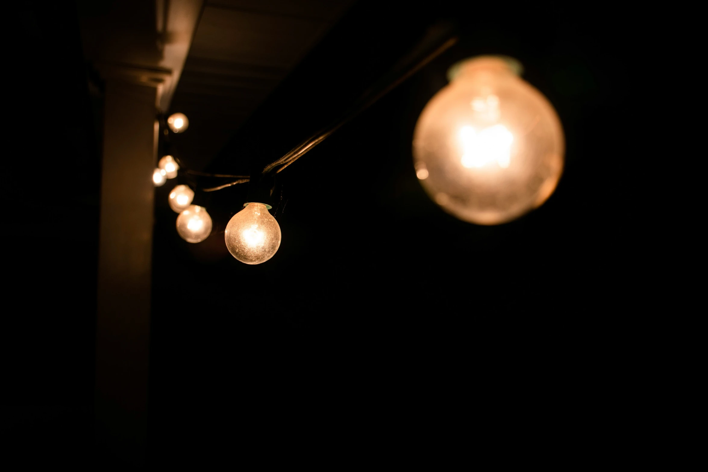 some balls are hanging from the ceiling on some lights