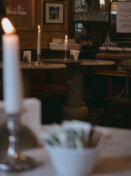 a candle is lit in a small white bowl