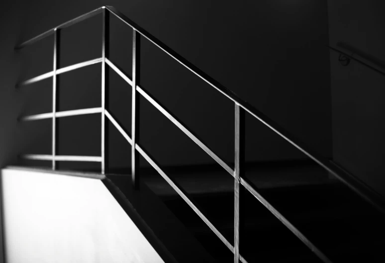 a railing next to a bed in a bedroom