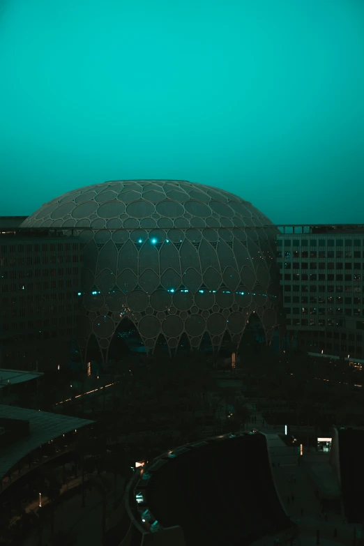 a large building with an intricate design and lit up street lights