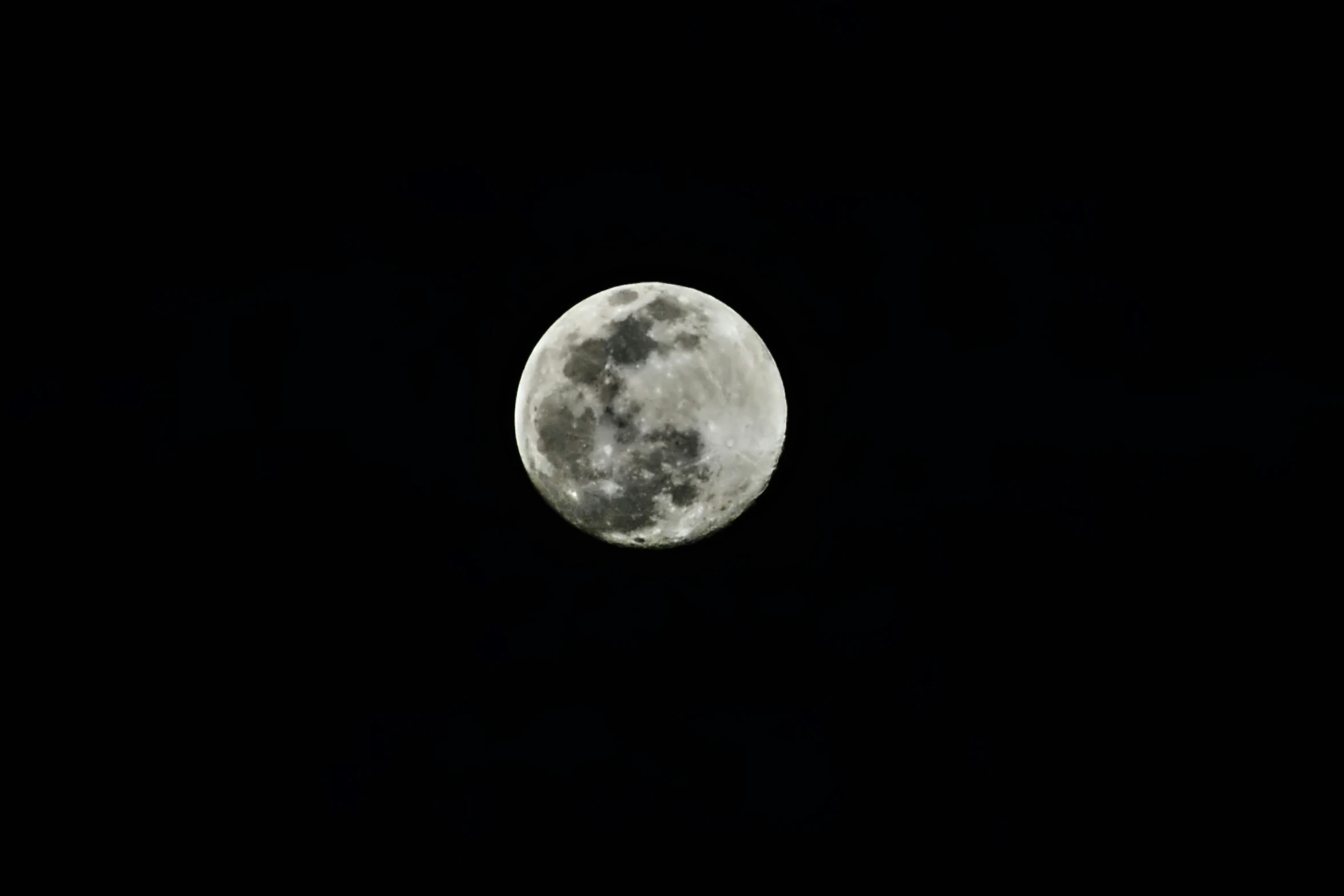 the full moon in the sky on an overcast night