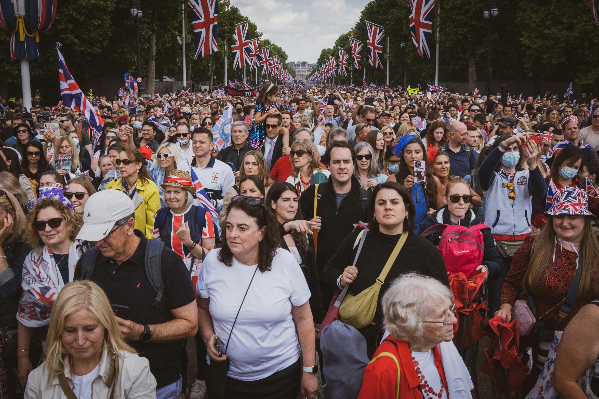 a large group of people walking down a street