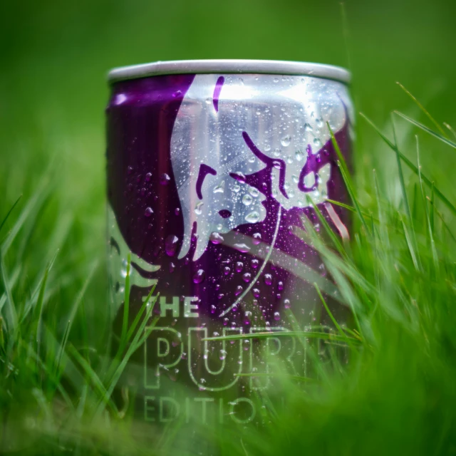 a can of puurtriato soda in the grass