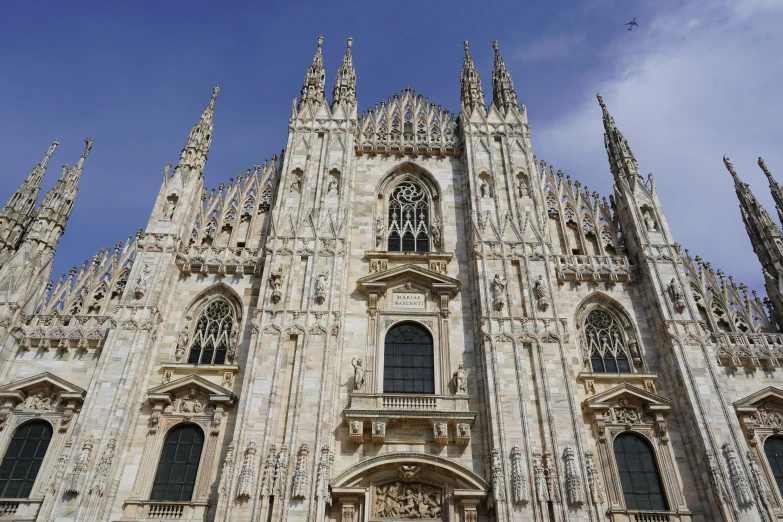 looking up at the magnificent architectural structure in front of blue sky