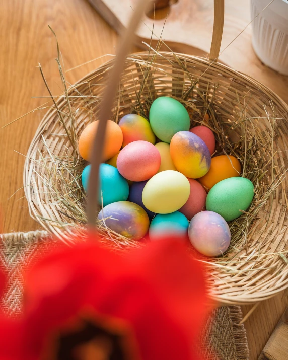 an easter basket filled with different colored eggs