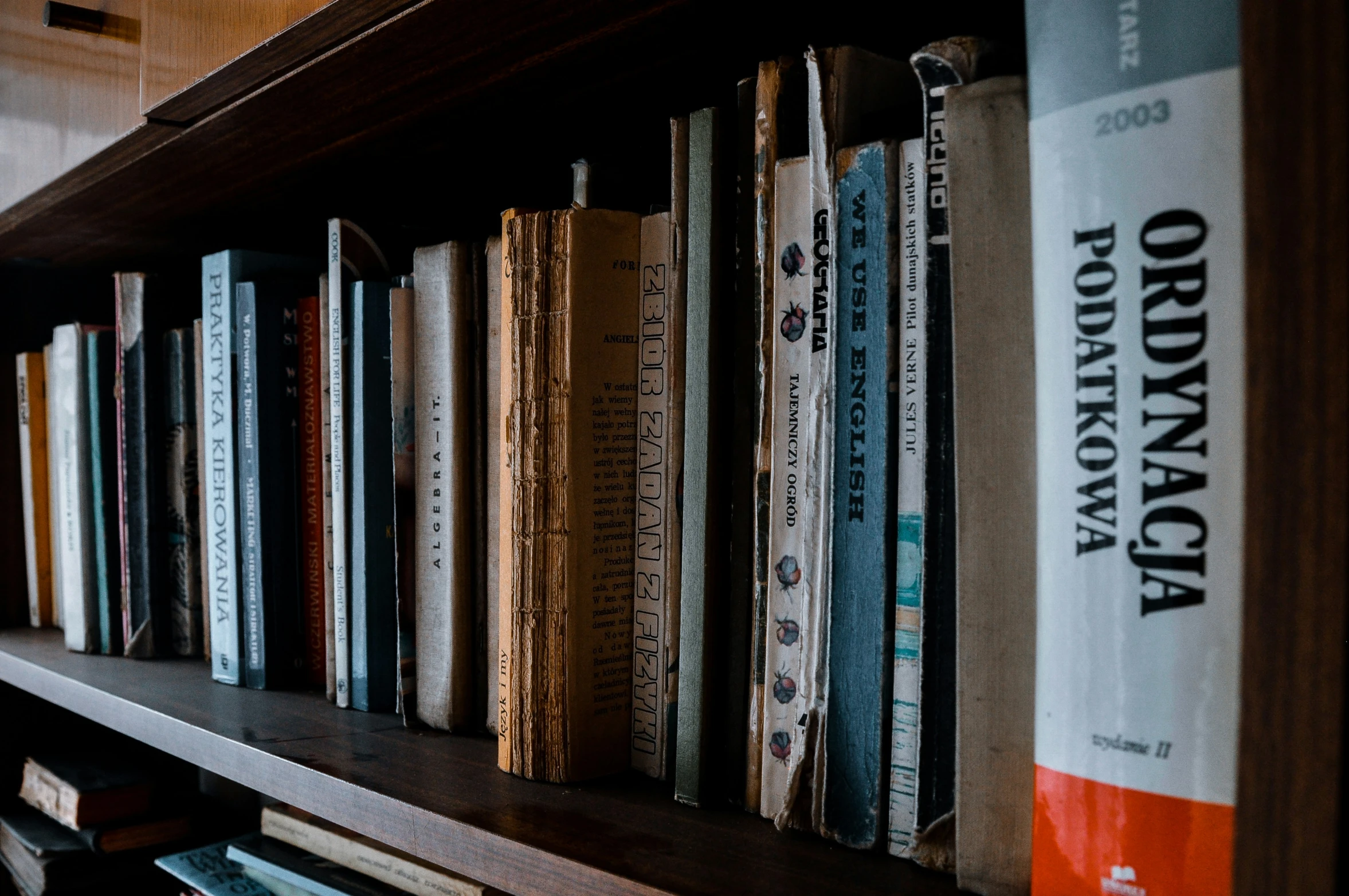 a bookshelf with several rows of different kinds of books on it