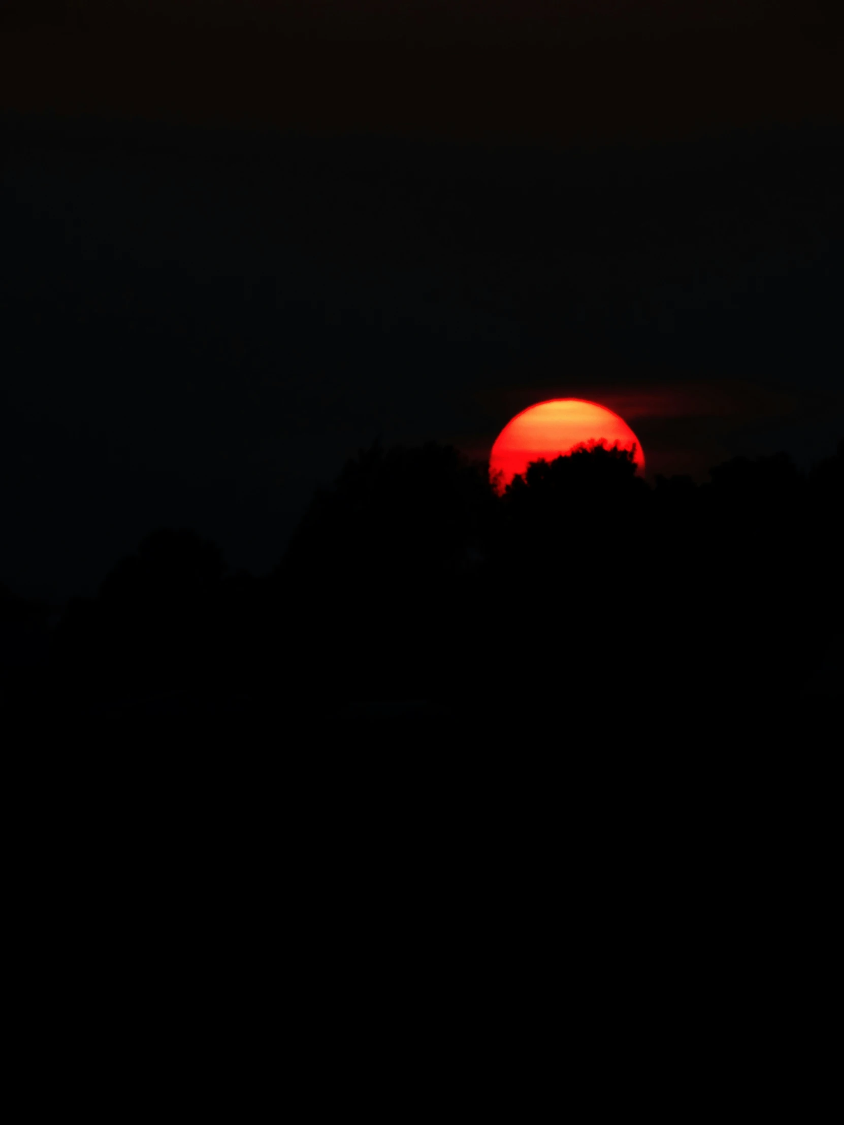 the sun is seen through some dark clouds