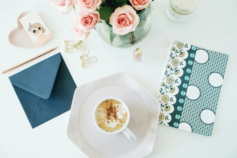 a cup of  chocolate and a flower and card