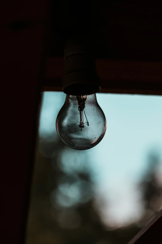 a light bulb hanging from the side of a window