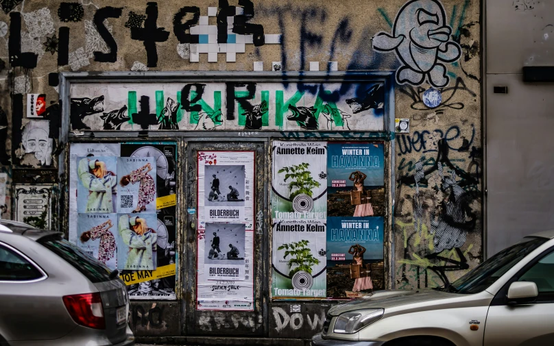 there is a wall that has been decorated with many different signs and graffiti