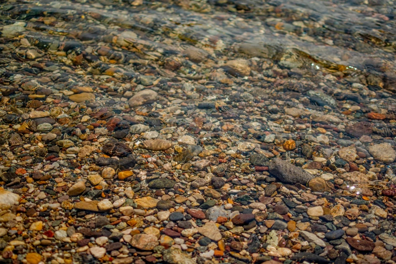 a small body of water with rocks and pebbles