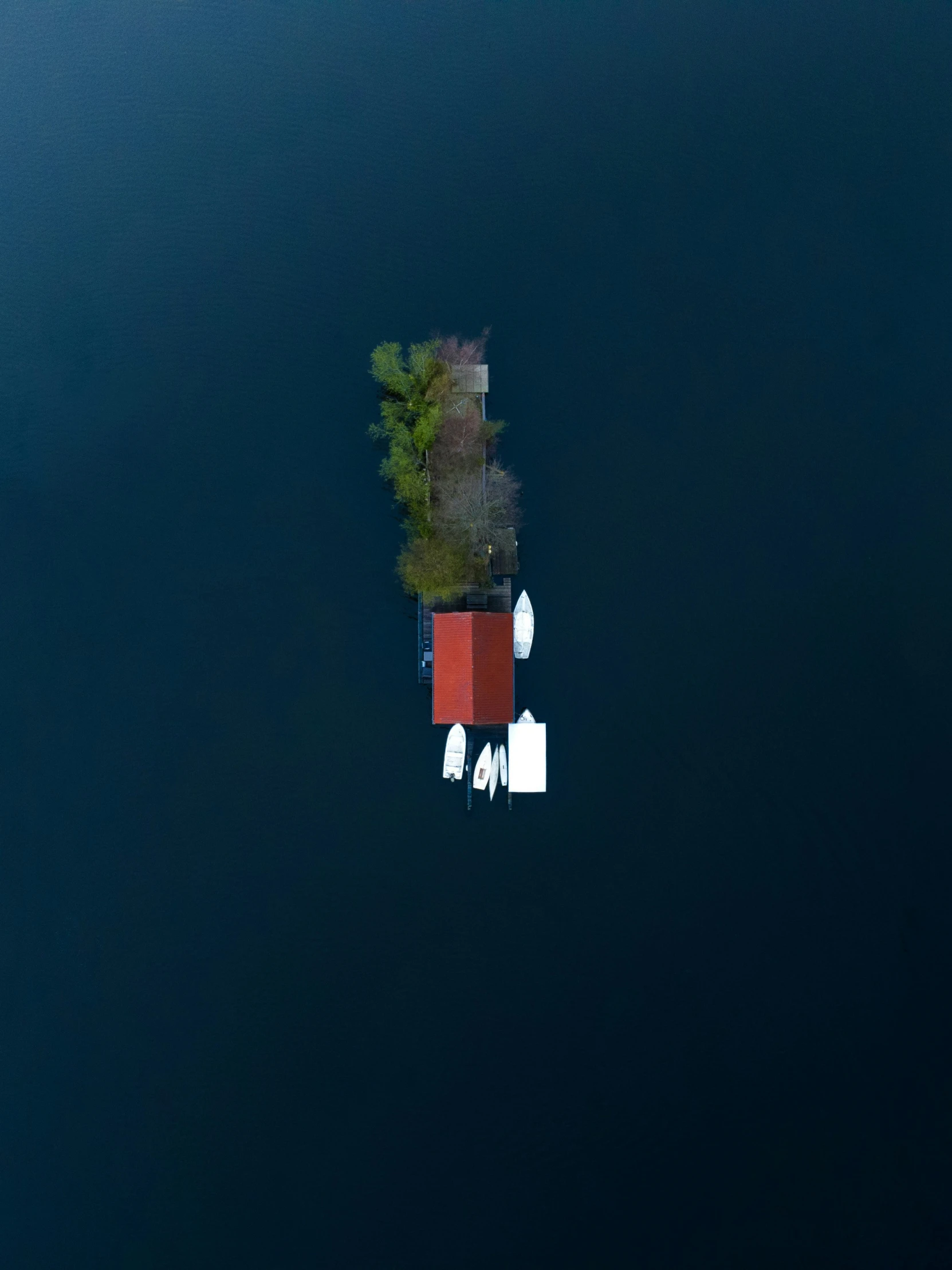 an island with some boats floating around it