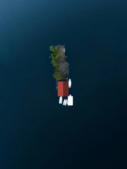 an island with some boats floating around it