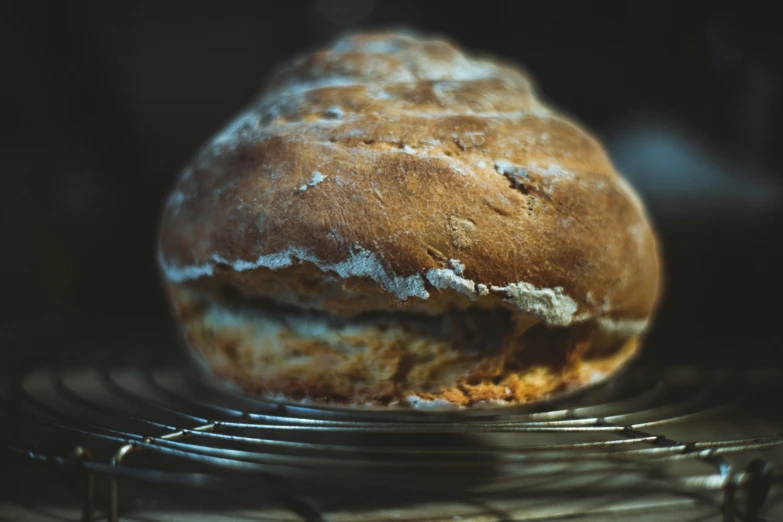 bread baked and cooling in a large metal basket