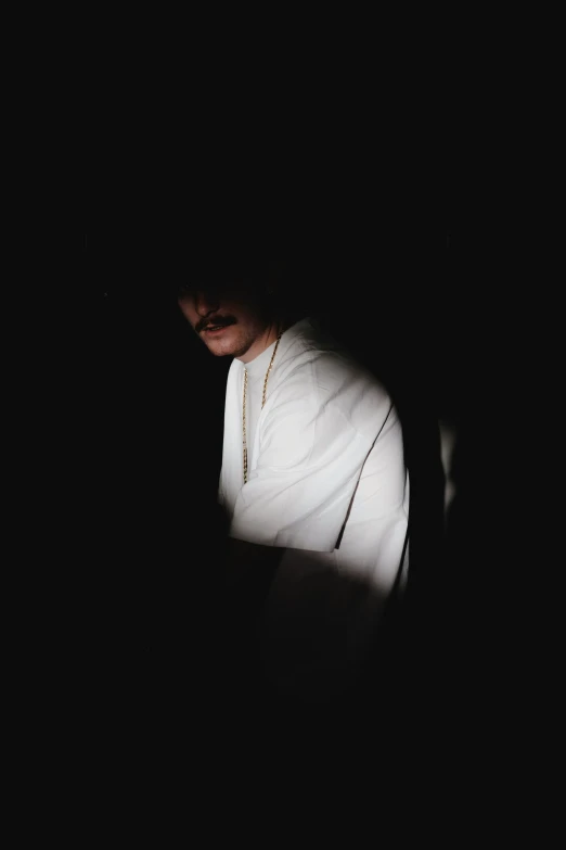a man holding a cell phone in the dark