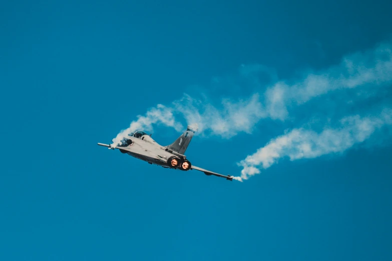 a airplane with smoke coming out of the back of it's wings