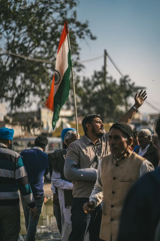 several people holding a flag and clapping