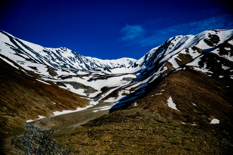 a view of the snow - covered mountain tops, which are brown