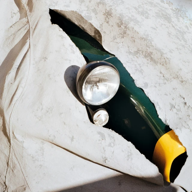 a green and yellow lamp sits on a concrete ledge