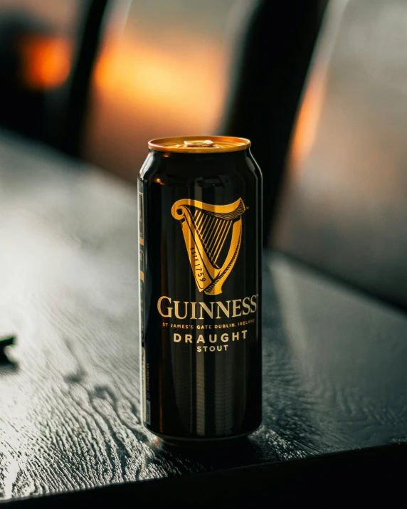 a can of guinness sitting on top of a wooden table