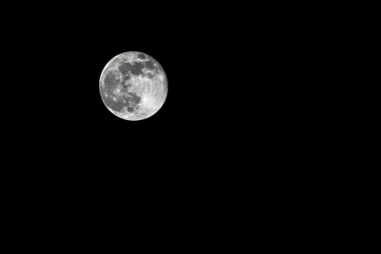 the moon is seen from across the sky