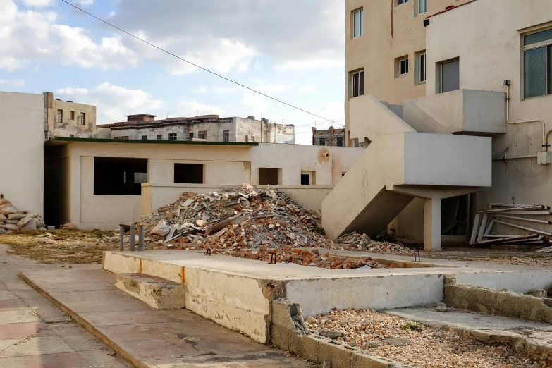 a pile of rubble next to a building under construction