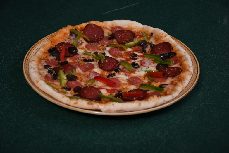 a pepperoni pizza with green peppers and pepperoni