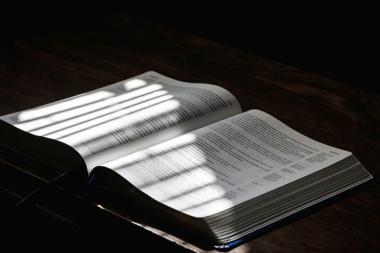 an open book sitting on a wooden table