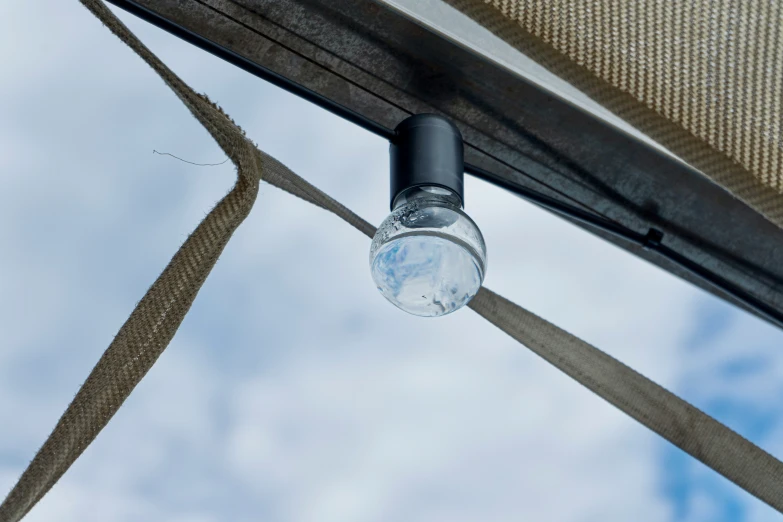 an outside area with hanging cloth and a small light bulb