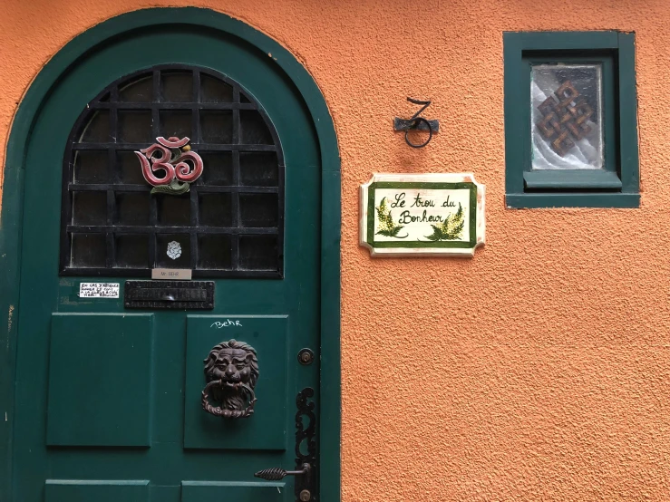 the door to an orange and green house is adorned with decorations