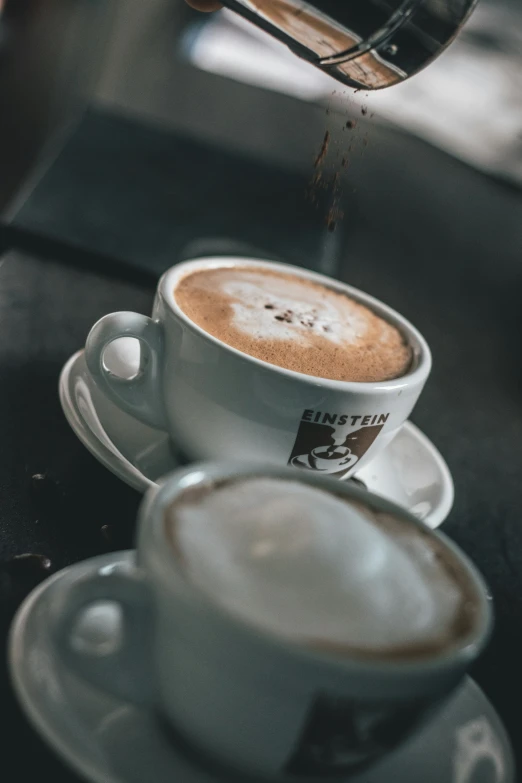 a cappuccino is being made in a coffee machine