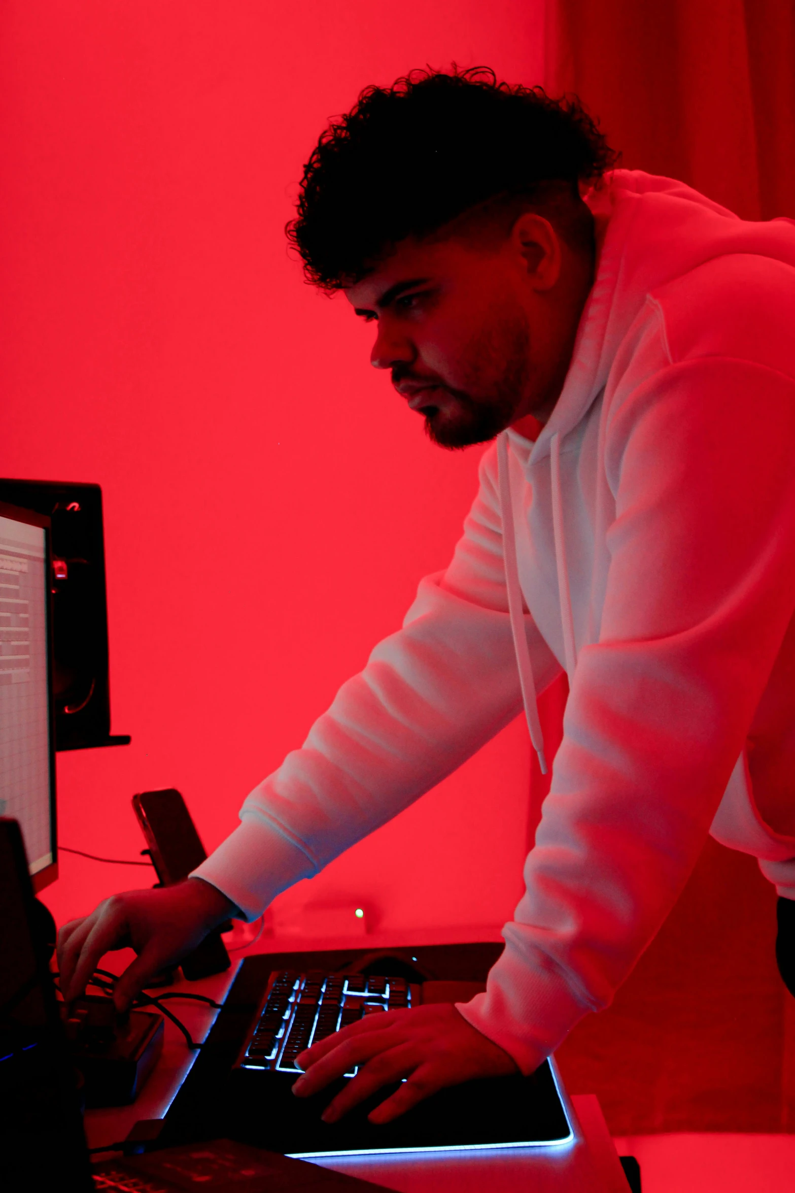 a man working on his computer in a room