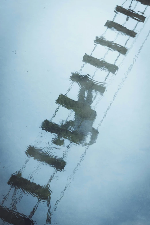 a tall metal ladder in the snow covered ground